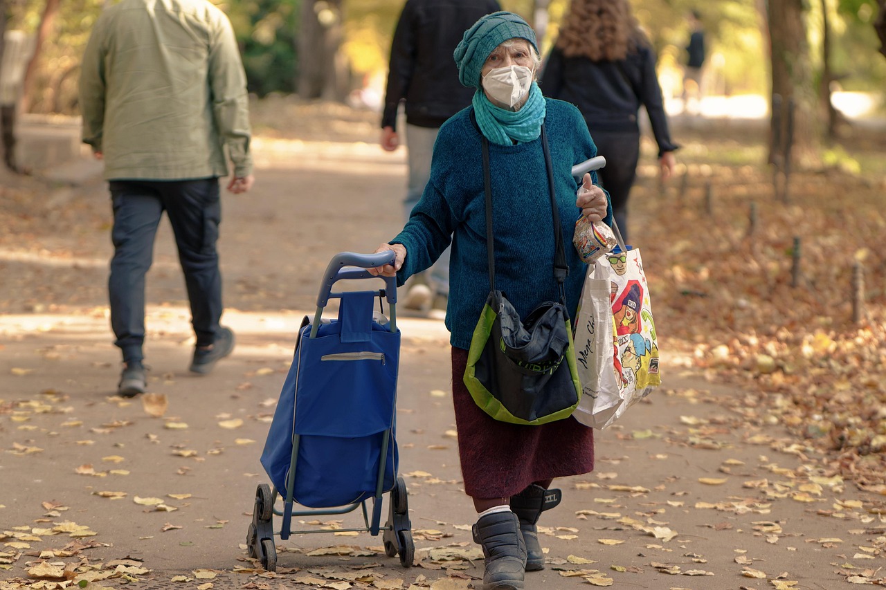 Anziano sorridente che consulta un documento su un tavolo, simbolo del bonus anziani 2025.