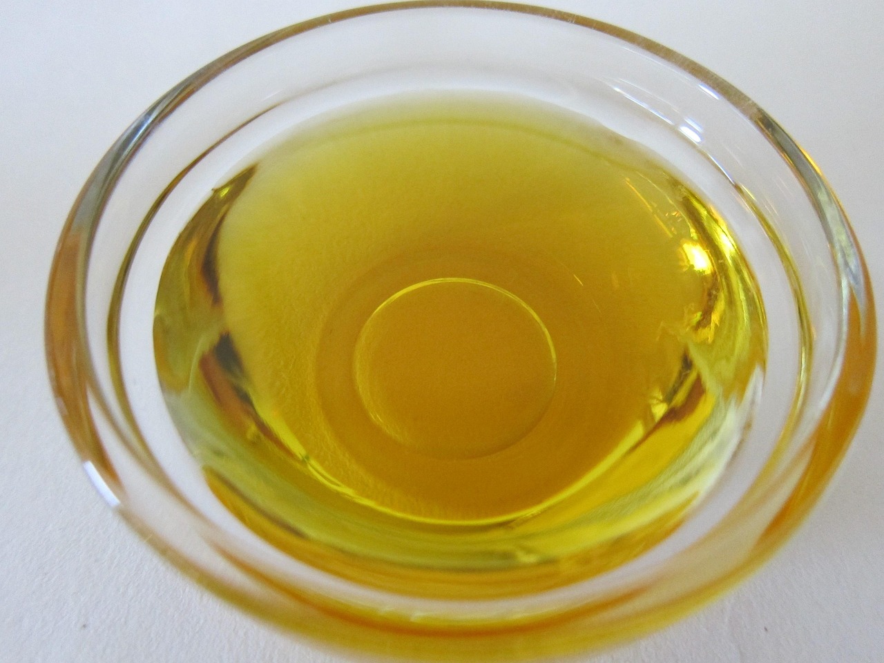 Olio d'oliva torbido in un contenitore, segnale di deterioramento e necessità di sostituzione.
