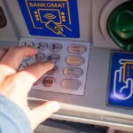 Bancomat con schermata di prelievo, evidenziando soglie e verifiche automatiche.